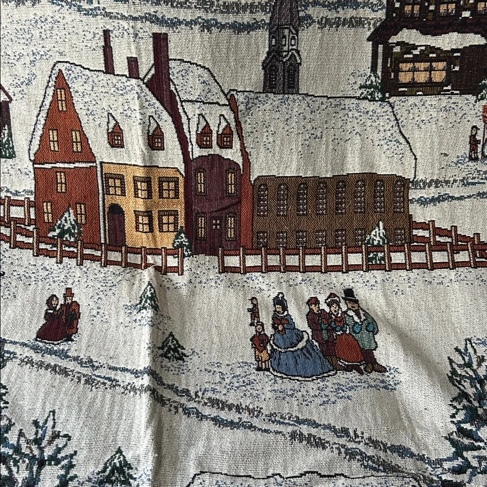 woven tapestry throw blanket featuring a winter village scene fringe edges